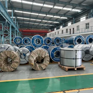 Cold rolled grain oriented steel coils stacked in a manufacturing warehouse