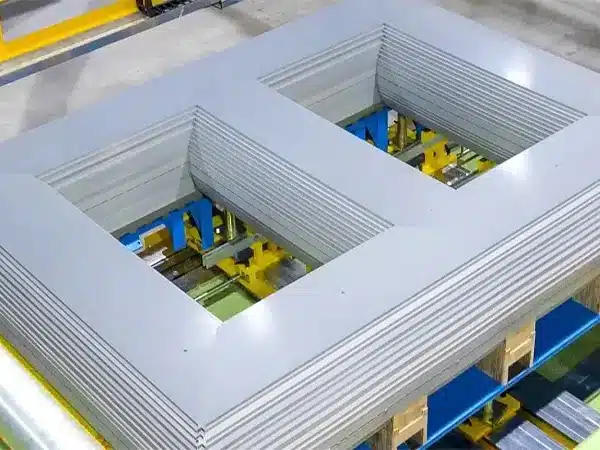 Transformer cores being stacked from grain-oriented steel laminations on a jig