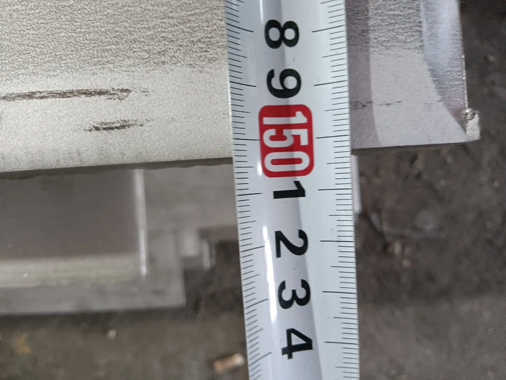 Inspector measuring electrical steel thickness with digital caliper during quality inspection