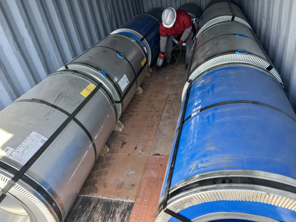 CRGO electrical steel coils secured inside shipping container for international export transportation