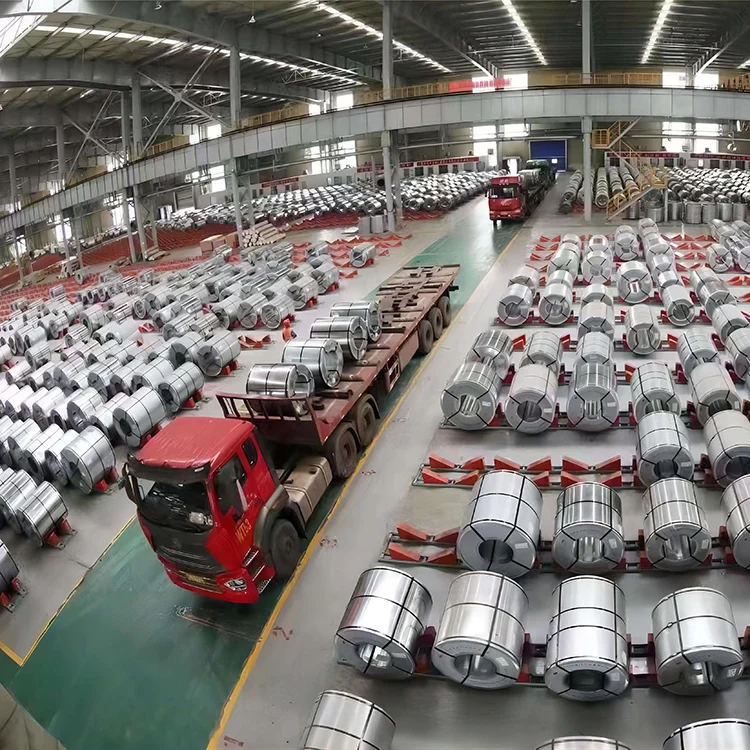 Aerial view of a warehouse holding thousands of electrical steel coils in labeled rows, with a red flatbed truck loading in the center aisle