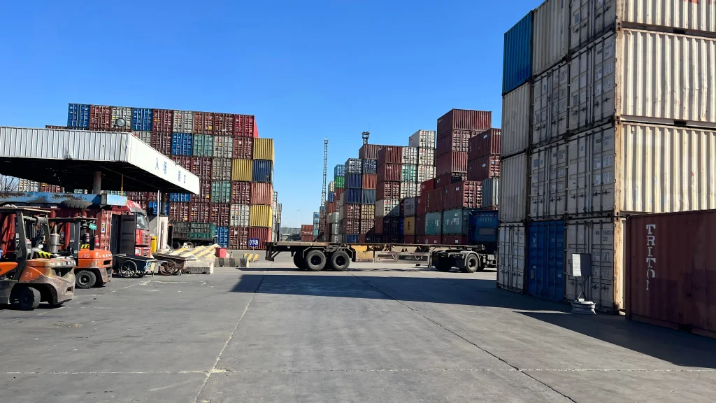 Global steel export logistics with shipping containers representing CRGO electrical steel supply chain movements