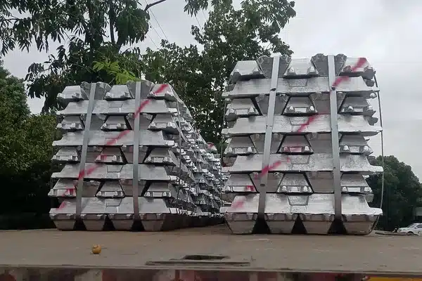Bundled stacks of primary aluminum ingots strapped on a flatbed truck