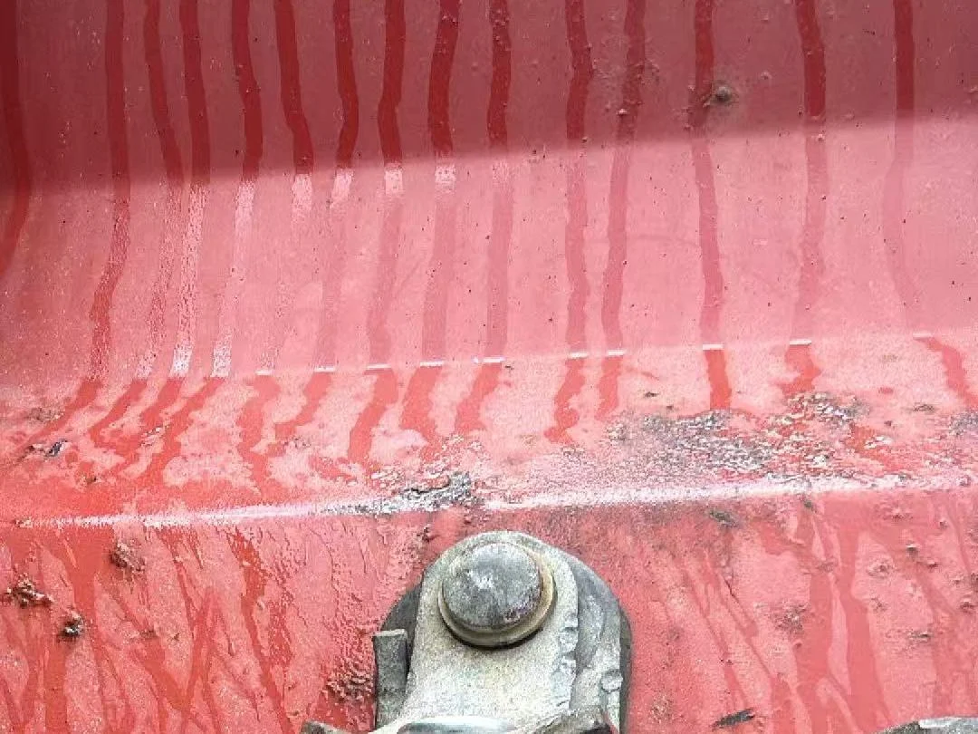 Close-up of a bolt seal on a shipping container door locking bar, seal number visible