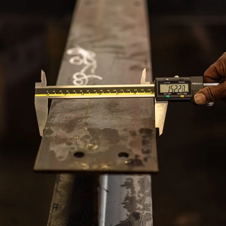 Digital caliper measuring the edge thickness of a steel strip with a numeric LCD readout
