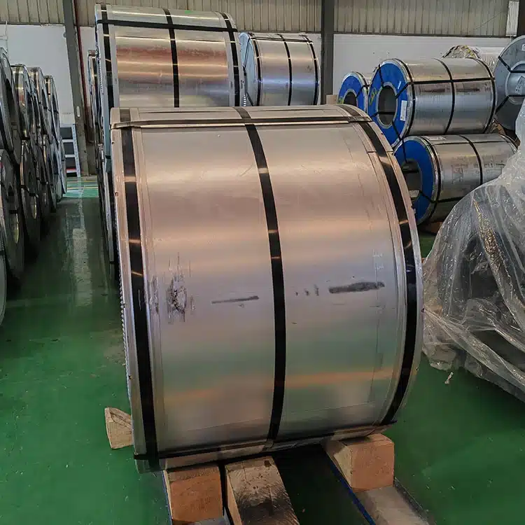 Close-up of coiled cold-rolled grain-oriented electrical steel sheets stacked in an industrial facility