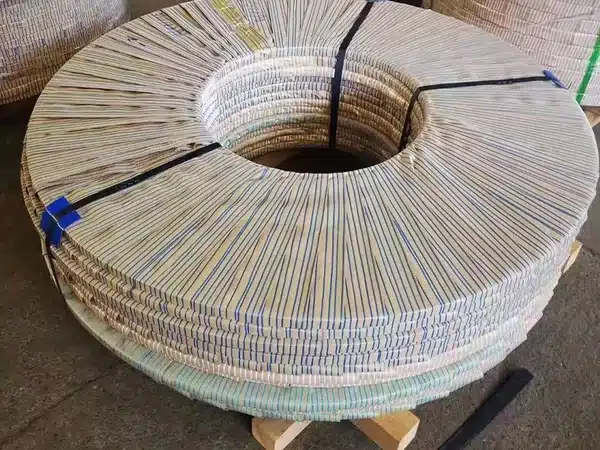CRNGO steel coil wrapped in anti-rust paper and steel-strapped, eye-to-sky on wooden skids