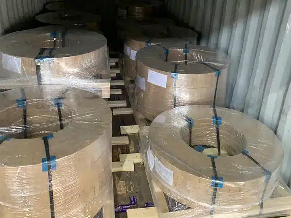 Packed CRNGO steel coils loaded and braced in a shipping container
