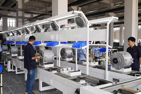 Workers assembling electric motor housings on a production line