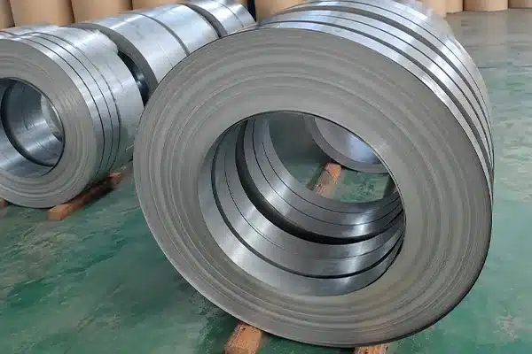 27Q120 grain-oriented electrical steel slit coils on timber skids in the workshop