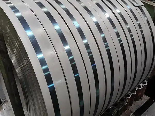 Grain-oriented electrical steel slit into narrow strips on the slitting line, held by steel bands