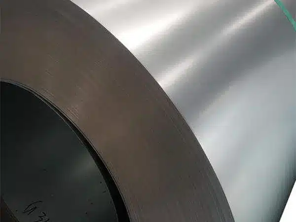 M6 CRGO steel coil close-up — wound edge and grey insulation-coated surface