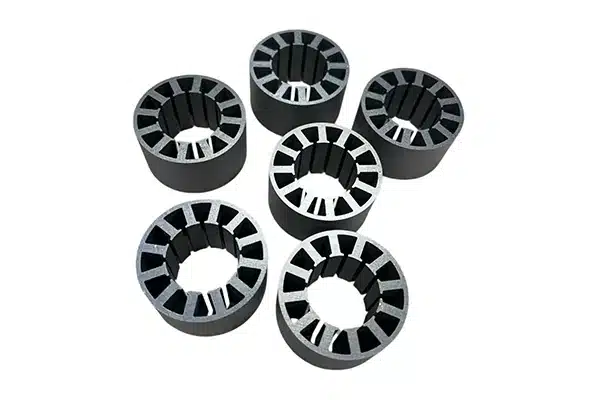Six small stator core stacks built from stamped electrical steel laminations